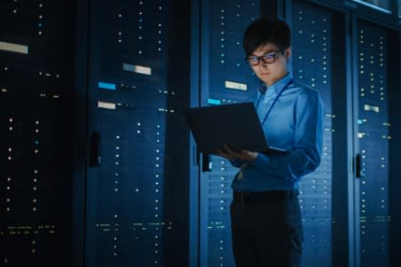 IT professional at datacenter reviewing data